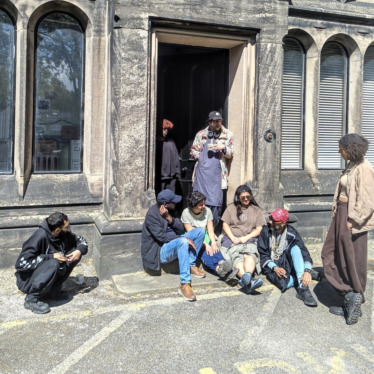 The retreat group gathered on the steps of a stone building at Bidston, seen from a distance