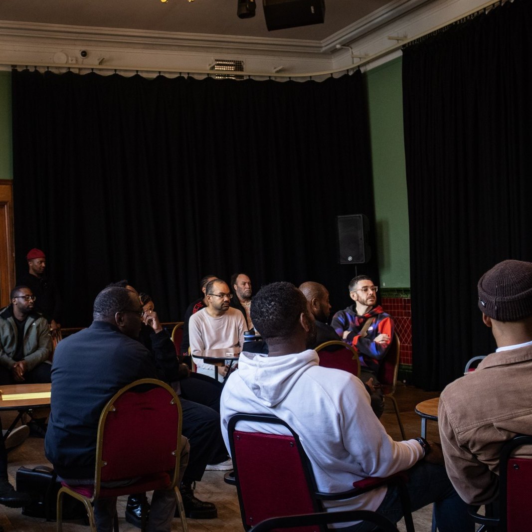 People seated at round tables in the Society Room at Stanley Arts for the Ivor's Compass launch