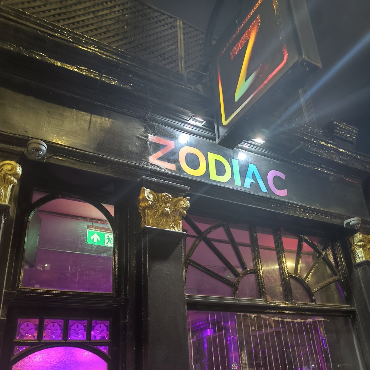The Zodiac bar lit up at night, where the picnic carried on into karaoke
